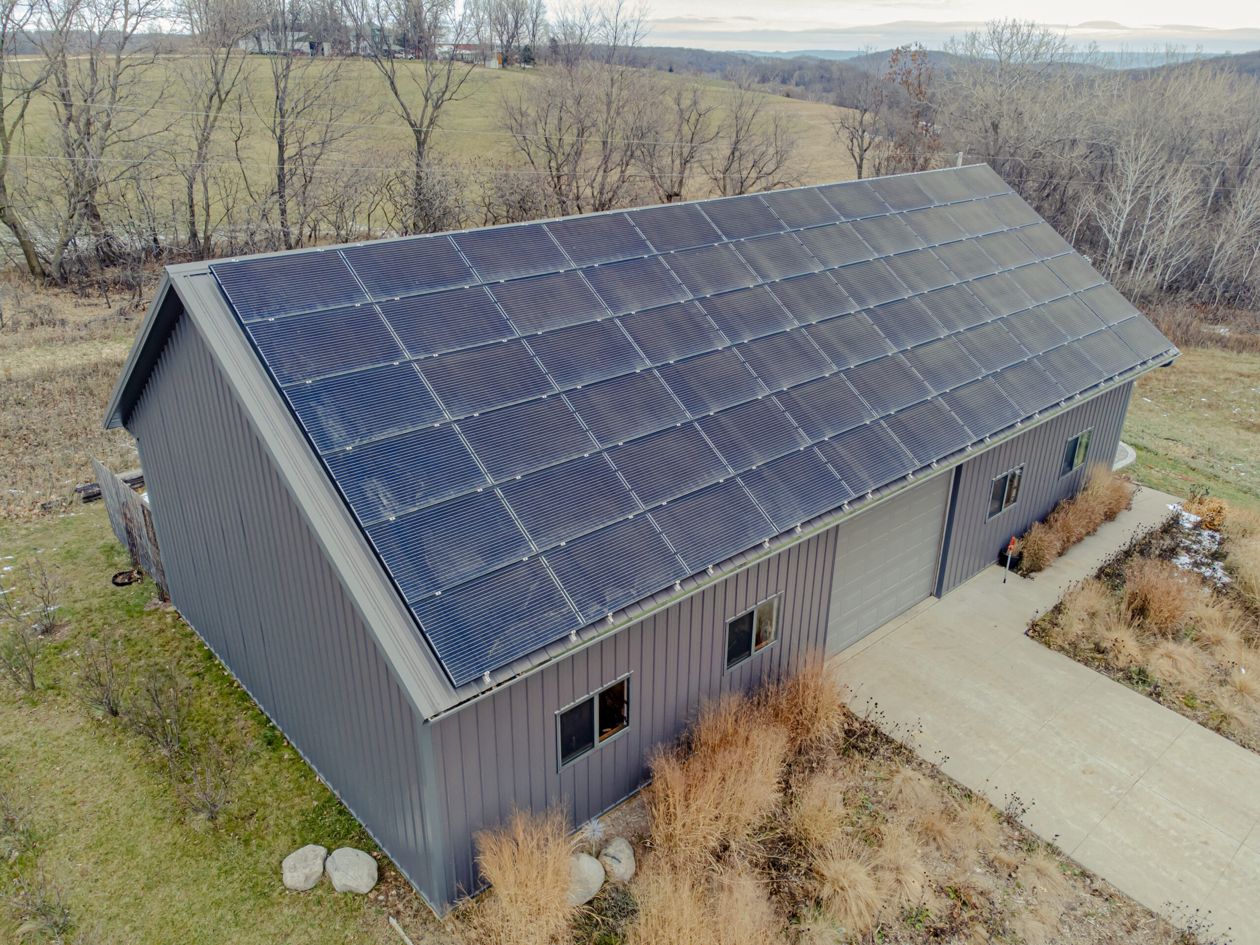 Roof-mounted solar panel array charging a battery bank